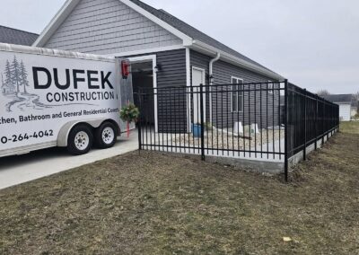 Kimberly WI: Black aluminum ornamental fence with a gate enclosing a new home