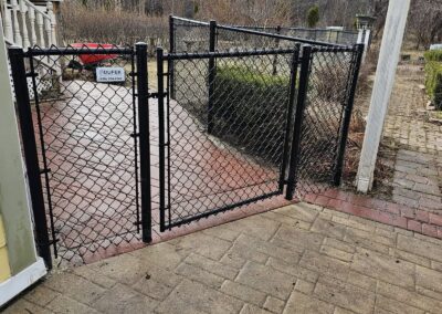 Little Chute WI: Black chain link fence with a gate at a patio entrance