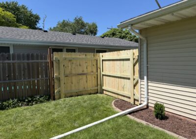 Menasha WI: Treated wood privacy fence and gate section beside a house